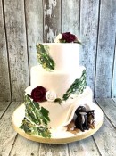 green-appique-buttercream-with-sugar-roses-and-sugar-dogs-peeking-out-