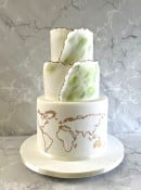 Green-hand-painted-wedding-cake-with-over-wrap-and-world-map-