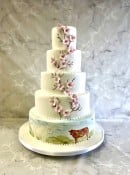 Delicate Cherry blossom wedding cake and hand painted farming scene 