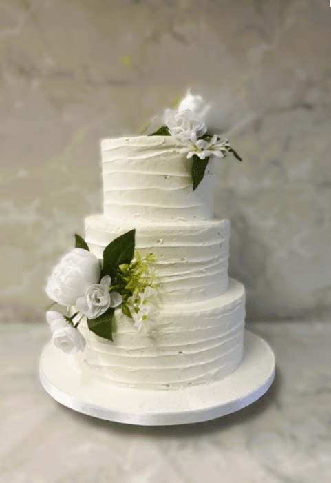 all in clusive wedding cake package pallet-knife-frosting-with-silk-flowers-