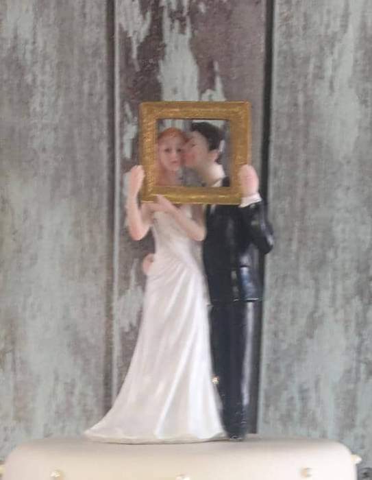 bride and groom  wedding cake topper holding photo frame