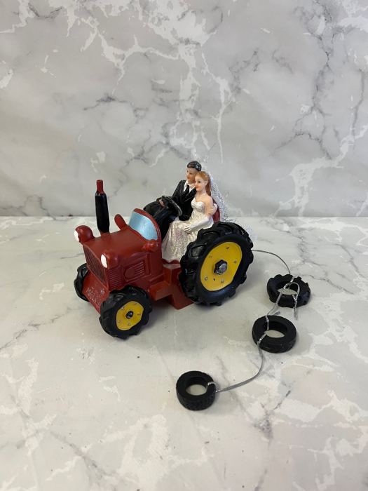 Farming countryside bride and groom on a tractor wedding cake topper