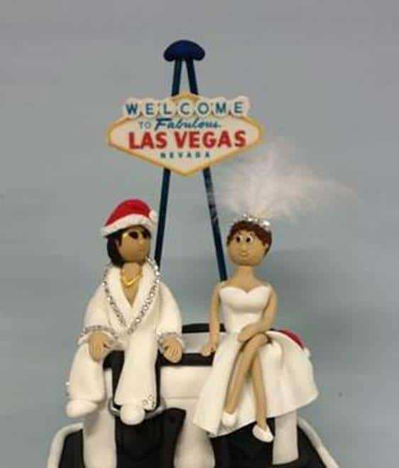 elvis and the showgirl wearing Christmas hats wedding cake topper