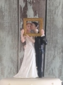 bride and groom  wedding cake topper holding photo frame