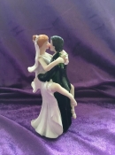 bride and groom  in an intimate embrace wedding cake topper