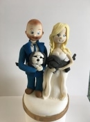sugar bride and groom wedding cake topper holding dogs