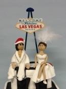 elvis and the showgirl wearing Christmas hats wedding cake topper
