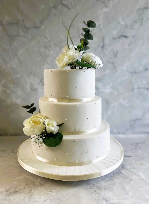 Royal icing hand piped pearls wedding cake with silk flowers