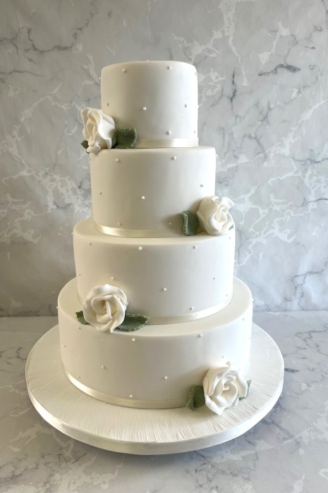 4-tier-Iris-wedding-cakde-witnh-delicate-pearls-and-sugatr-roses