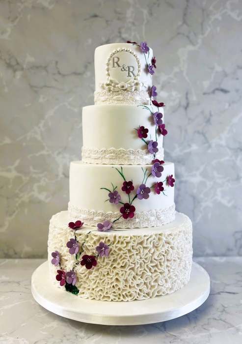 Delicate-blossoms-with-lace-ribbons-and-ruffles-wedding-cake-