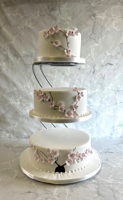 Delicate-cherry-blossoms-wedding-cake-on-a-stand