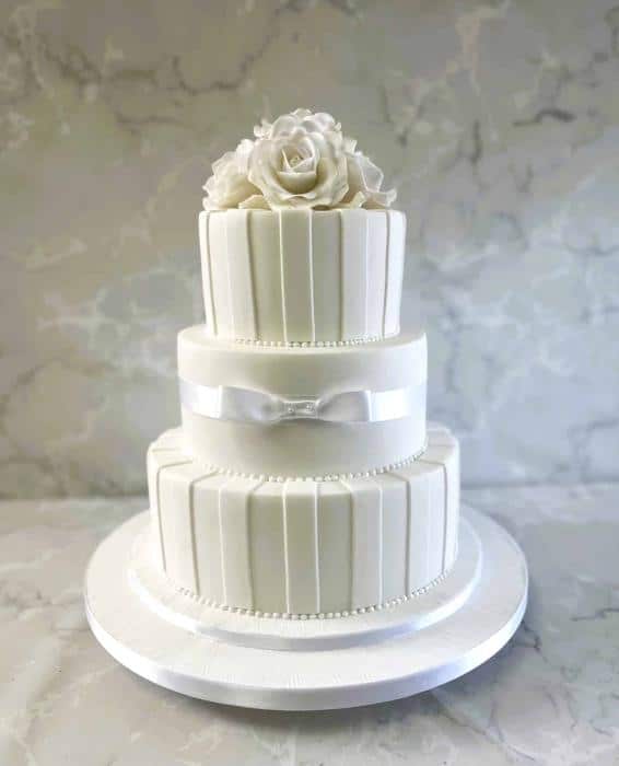 Hand cut icing stripes topped of with delicate roses wedding cake