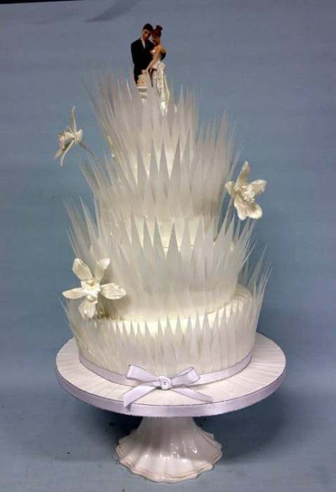 Topsy Turvy winter wedding cake with edible feathers