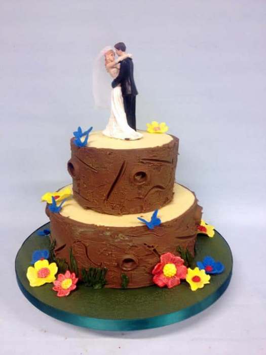 Tree logs wedding cake with sugar blossoms and butterflies