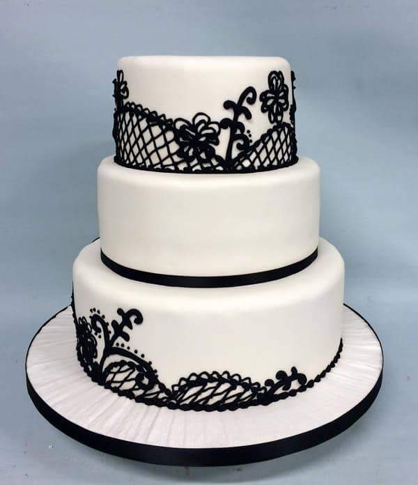 Black and white hand piped ornate wedding cake