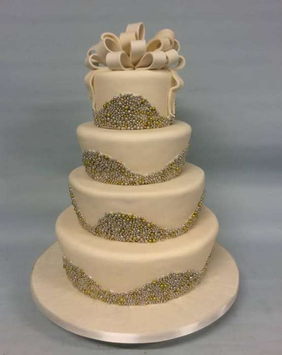 silver and gold beads Wedding cake with white sugar loops