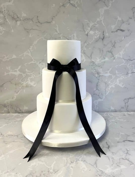 Wedding cake with trailing black satin bow