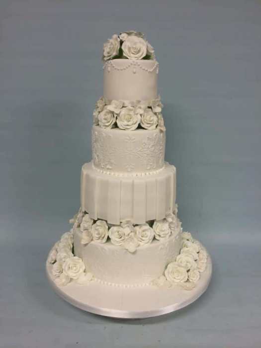 white wedding cake with Damask , roses and icing stripes