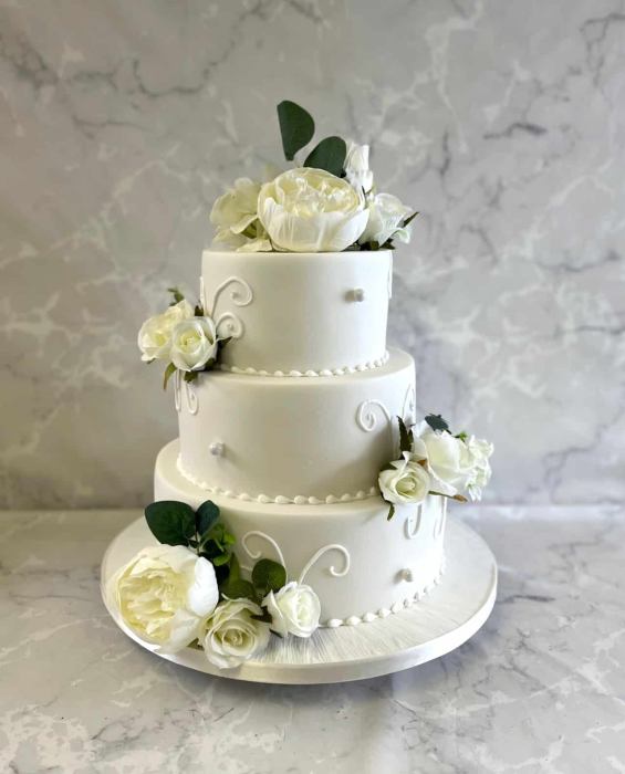 Royal Icing swirls wedding cake with silk flowers