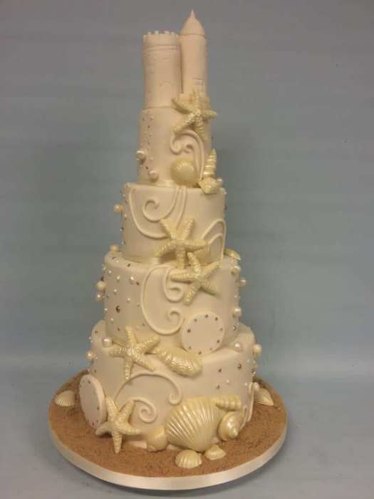 Seaside design wedding cake with chocolate shells and sand castle