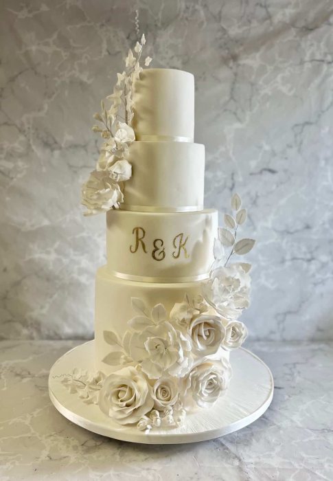 Tall wedding cake with oversized sugar flowers