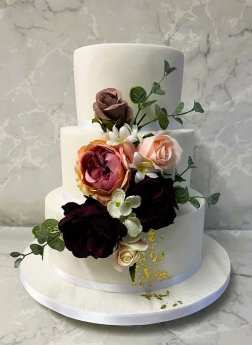 Iced-wedding-cake-with-gold-leaf-and-silk-flowers-wedding cake