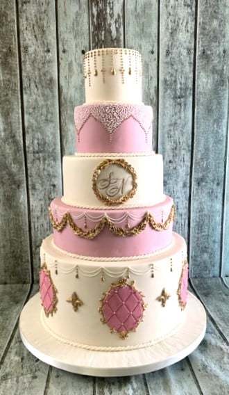 Ornate-large-pink-and-gold-adorned-wedding-cake-