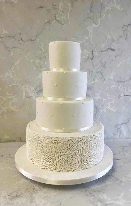 classic-White-wedding-cake-with-pearls-an-deep-rosettes