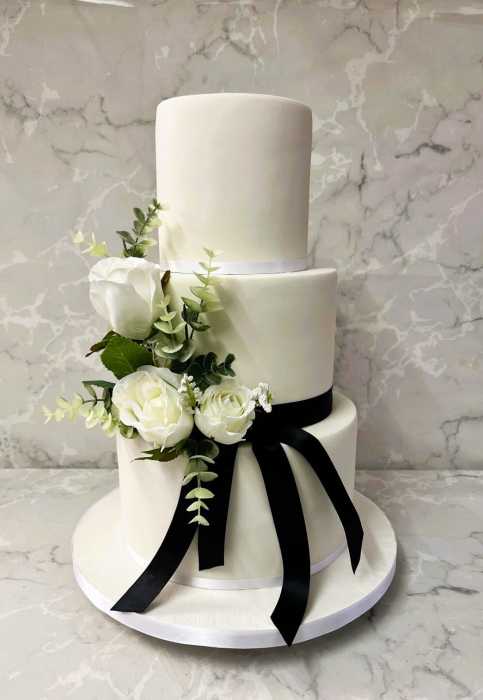 Slender elegant wedding cake with black bow