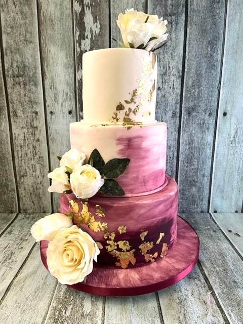 hand-painted-iced-wedding-cake-with-gold-leaf-and-silk-flowers-