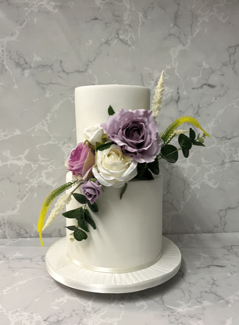 iced-barrelled-wedding-cake-with-silk-flowers-