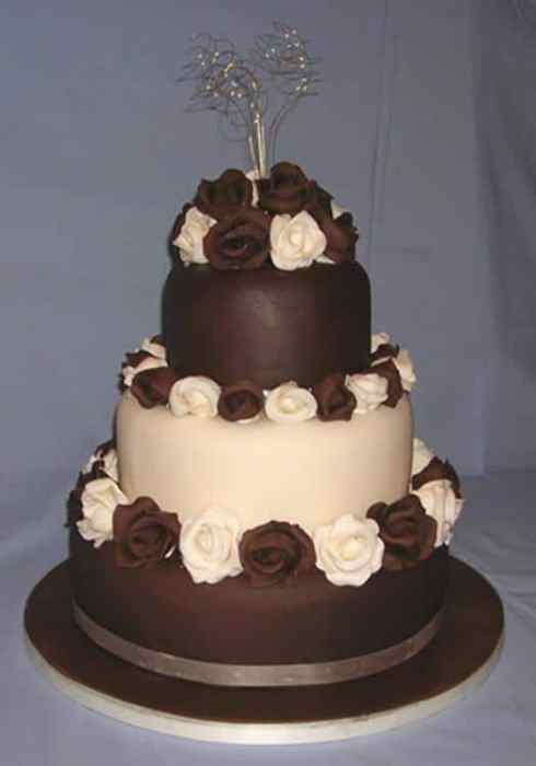 Brown and white wedding cake with sugar roses