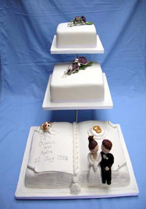 book and square wedding cake on a stand