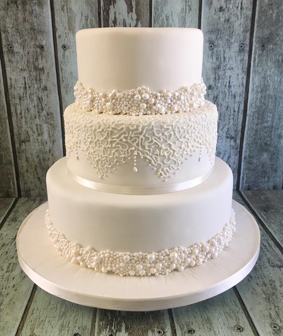 pearl bands and lace wedding cake