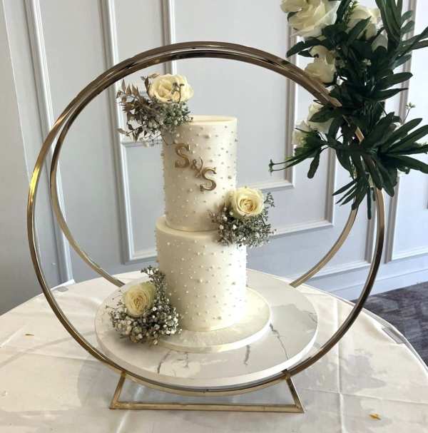 Tall wedding cakes adorned with edible pearls