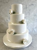 4-tier-Iris-wedding-cakde-witnh-delicate-pearls-and-sugatr-roses