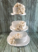 Wedding cake on a stand with sugar roses