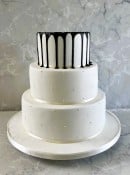 Delicate hand piped Pearls and a dramatic Black chocolate drip wedding cake 