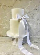 Elegant tall wedding cake with satin draping ribbon wedding cake 