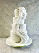 Wave of sugar paper and edible pearls wedding cake 