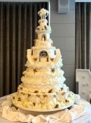 Extra large wedding cake with sugar decorations and silk flowers 