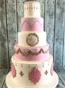 Ornate-large-pink-and-gold-adorned-wedding-cake-