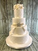 Quilted-wedding-cake-with-pearl-brooch-and-sugar-roses-
