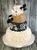 gold sequin and black wedding cake with ruffles