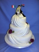 wedding cake with flags and satin drapes