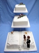 book and square wedding cake on a stand