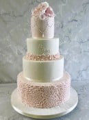 pale-pink-rosettes-wedding-cake-and-pearl-necklace
