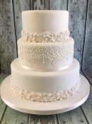 pearl bands and lace wedding cake