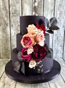 satin-black-iced-wedding-cake-with-silk-flowers-and-gold-leaf