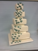 square wedding cake with cascading butterflys